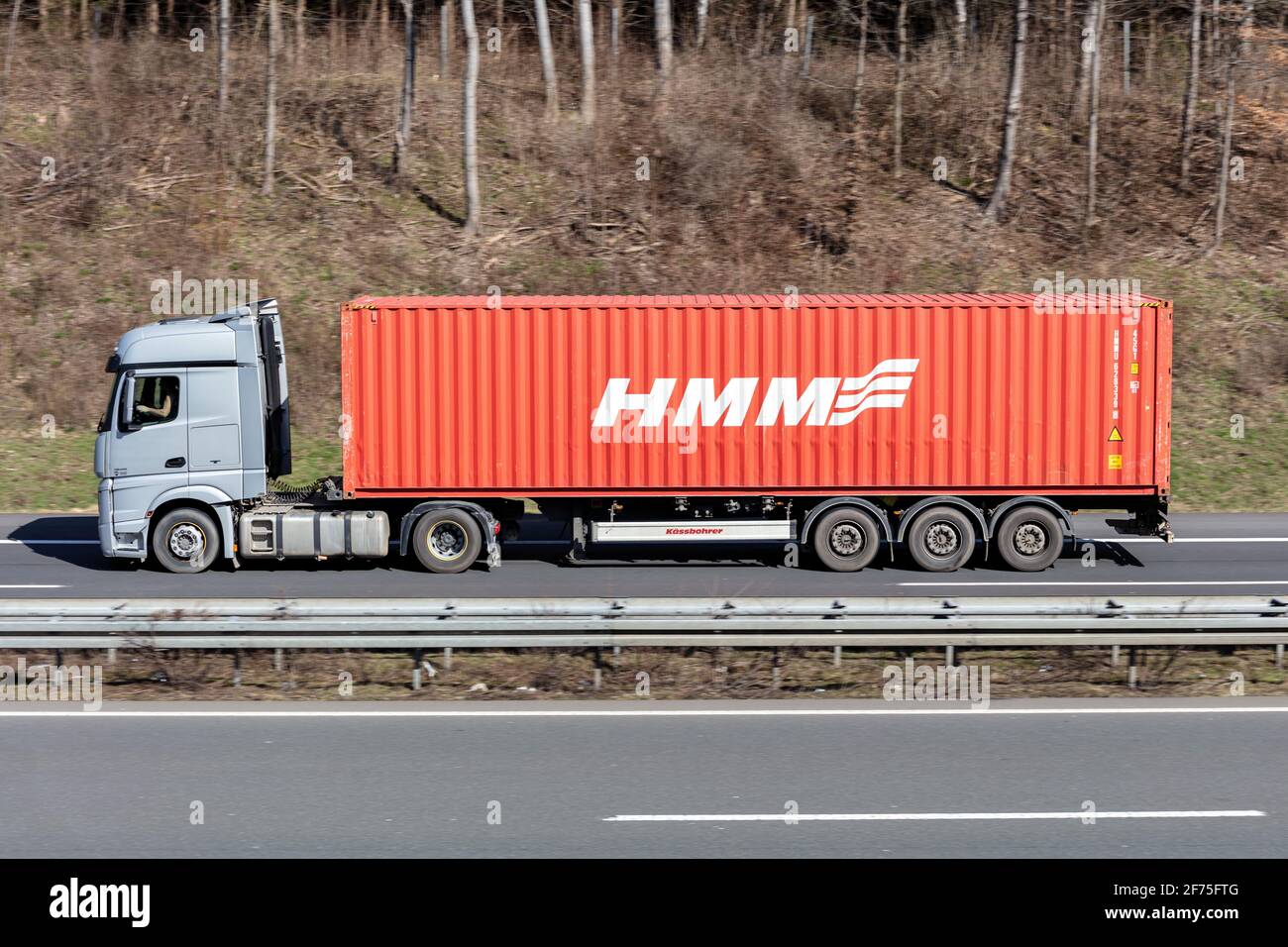 Mercedes-Benz Actros truck with HMM container on motorway. Stock Photo