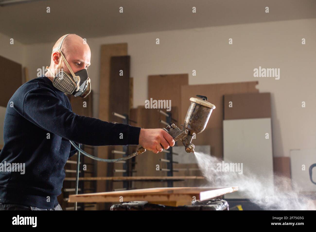 Staining a wood with white spray gun, application of flame retardant
