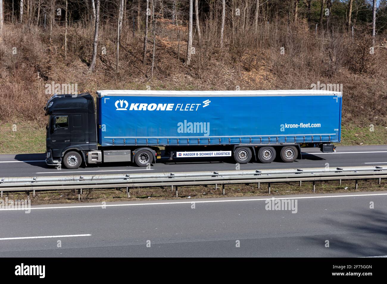 DAF XF truck with Krone Fleet curtainside trailer on motorway. Stock Photo