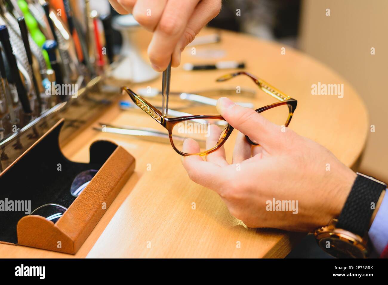 Optician repairing eye glasses stock photo Stock Photo
