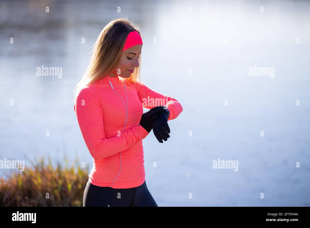 Sporty girl checking out her fitness tracker watch Stock Photo