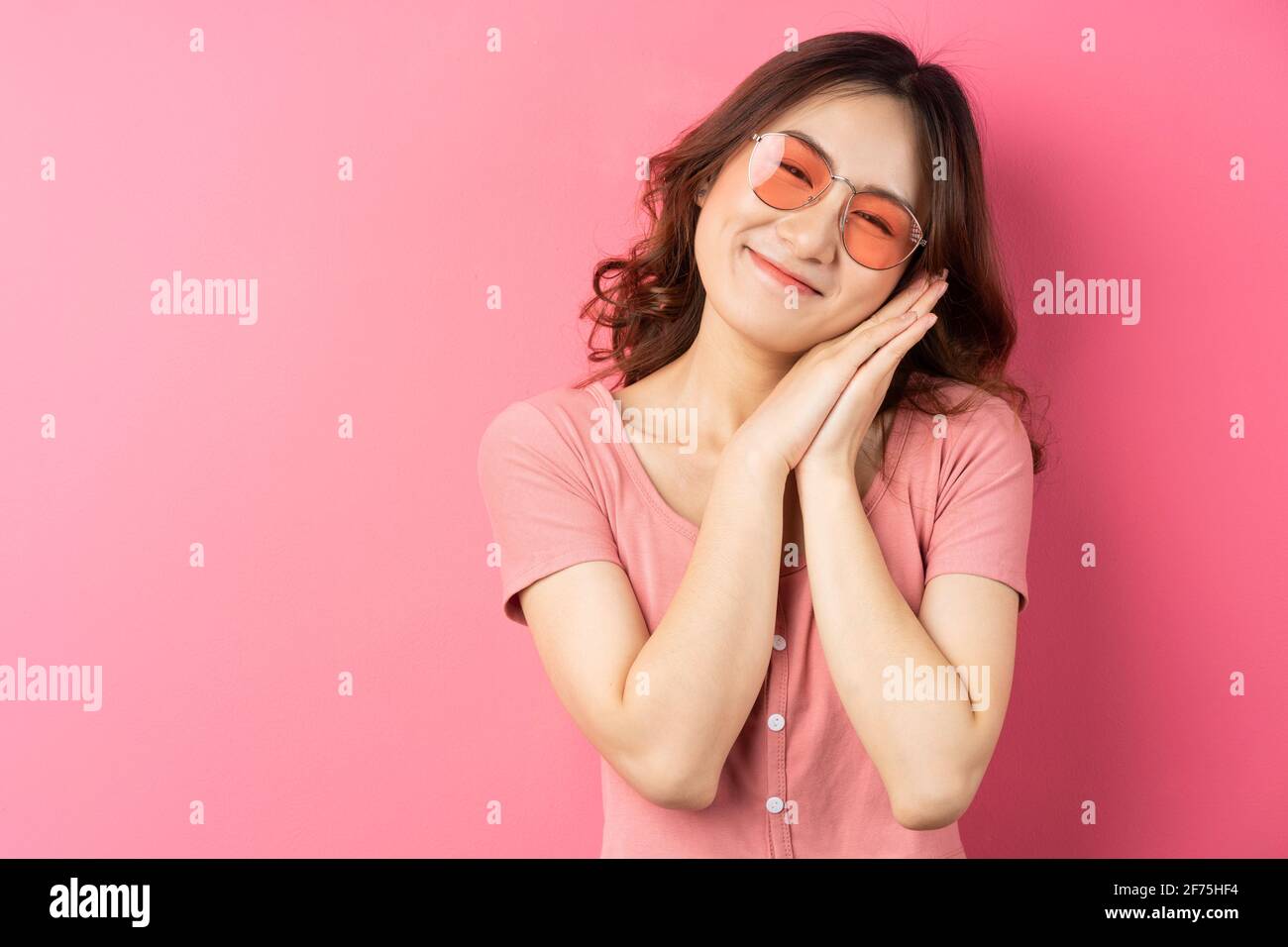 Young asian girl wearing glasses with cheerful expression on a pink background Stock Photo