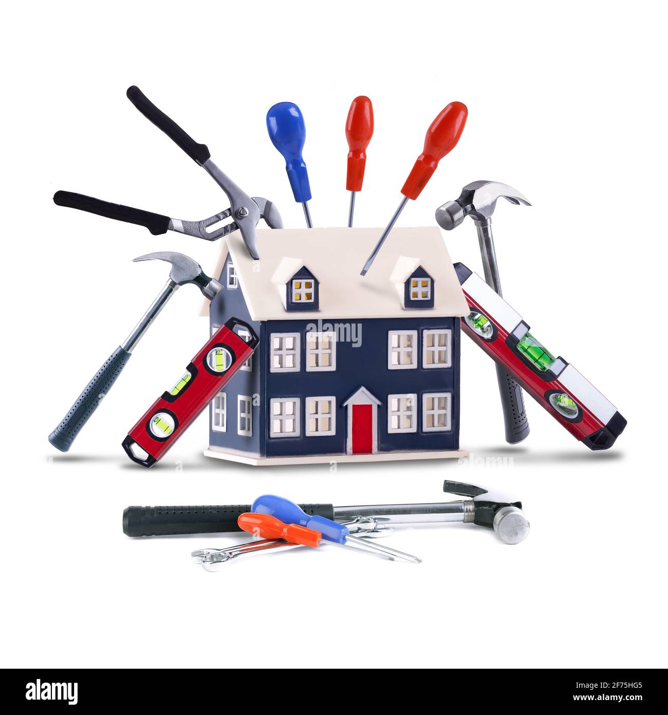 Home repair and maintenance concept with handyman tools on a toy house. Isolated on white background Stock Photo