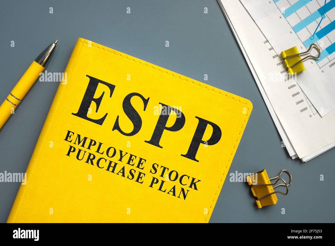 Employee Stock Purchase Plan ESPP and papers with charts and pen. Stock Photo