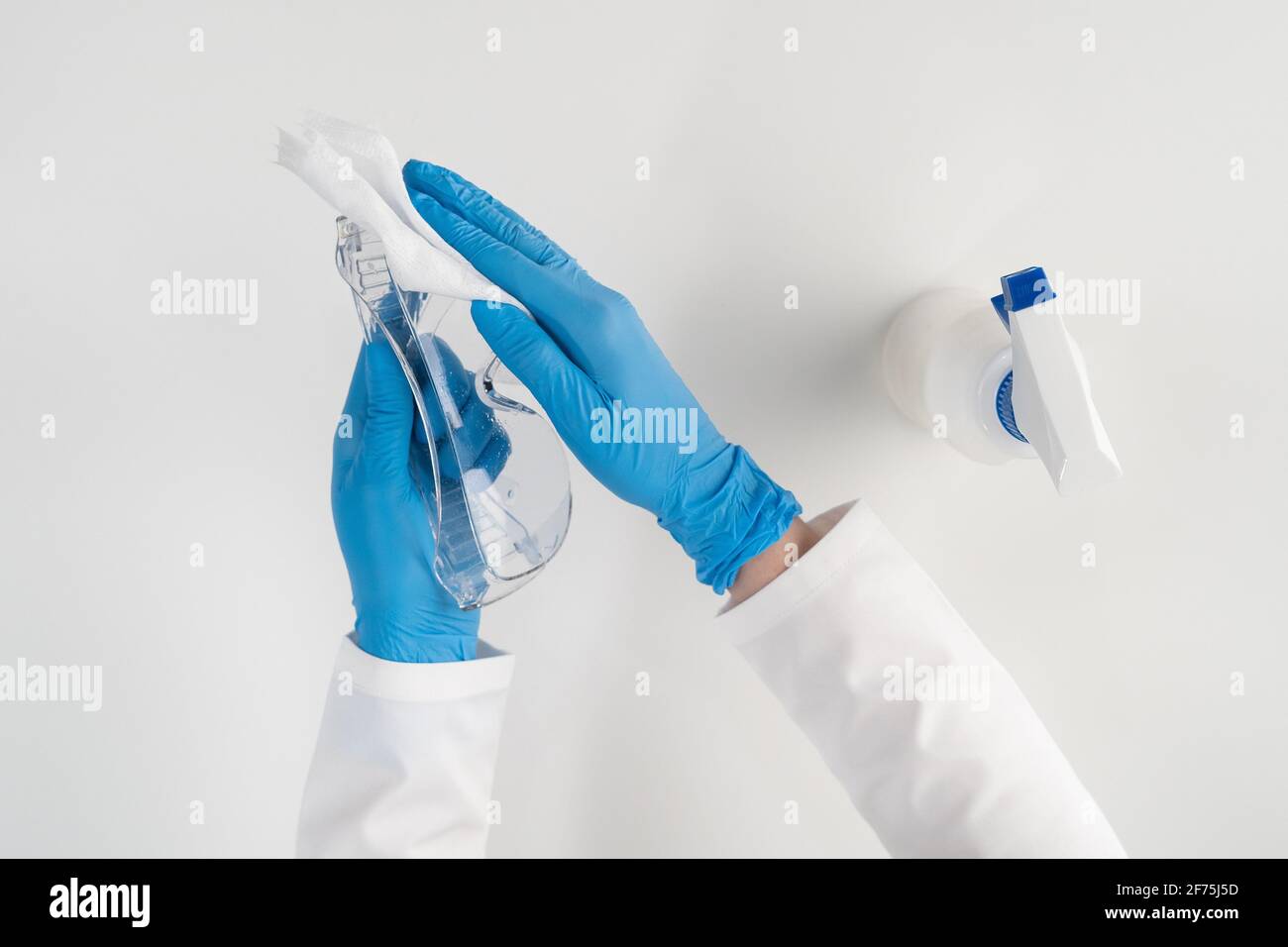 After use, the doctor wipes the safety glasses with a rag with an