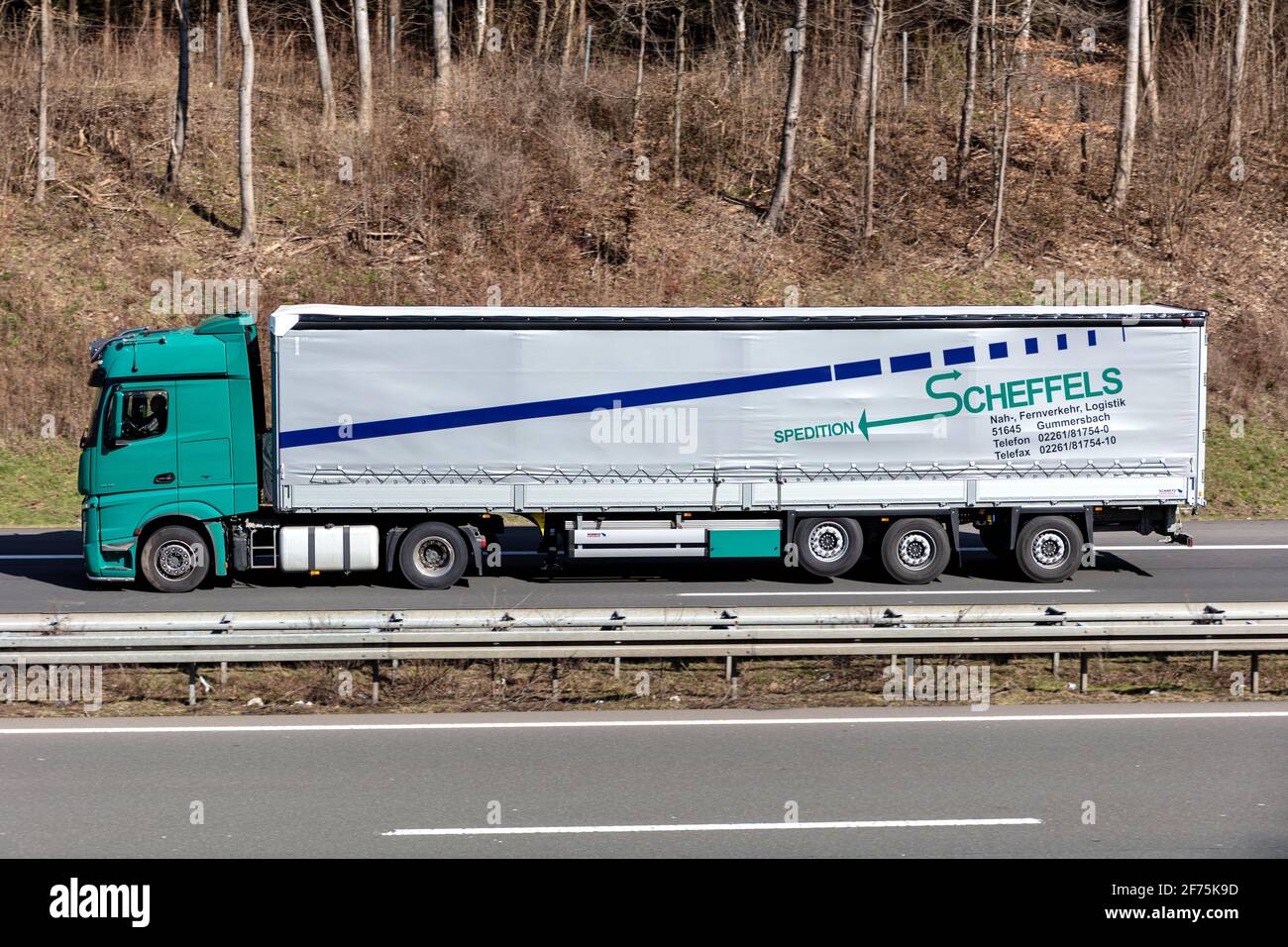 Spedition Scheffels Mercedes-Benz Actros truck with tarpaulin trailer on motorway. Stock Photo