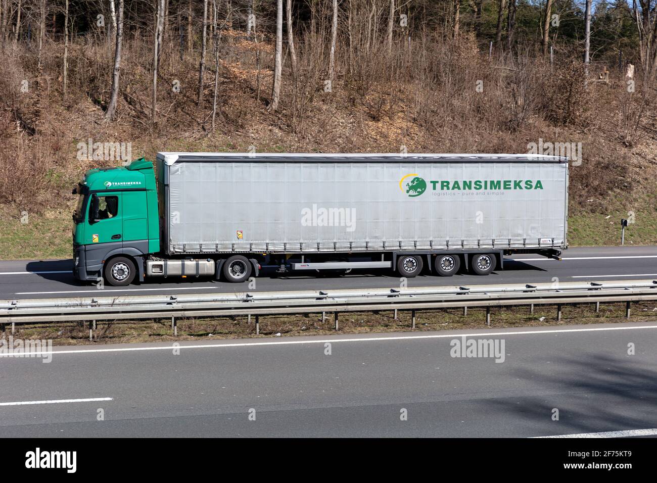 Transimeksa Mercedes-Benz Actros truck with curtainside trailer on motorway. Stock Photo