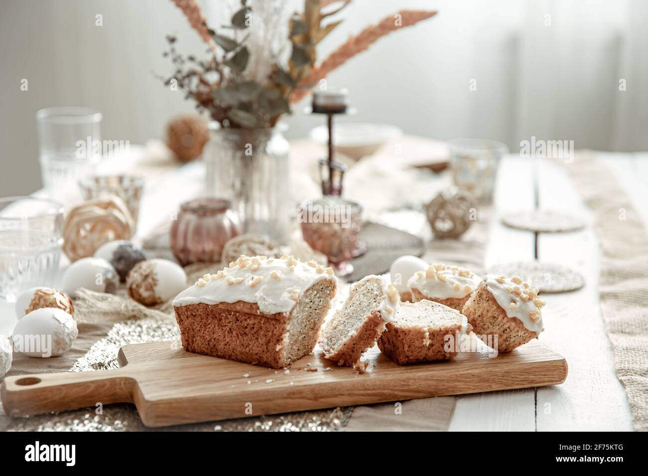 A festive table with a beautiful setting and freshly baked Easter cake. Stock Photo