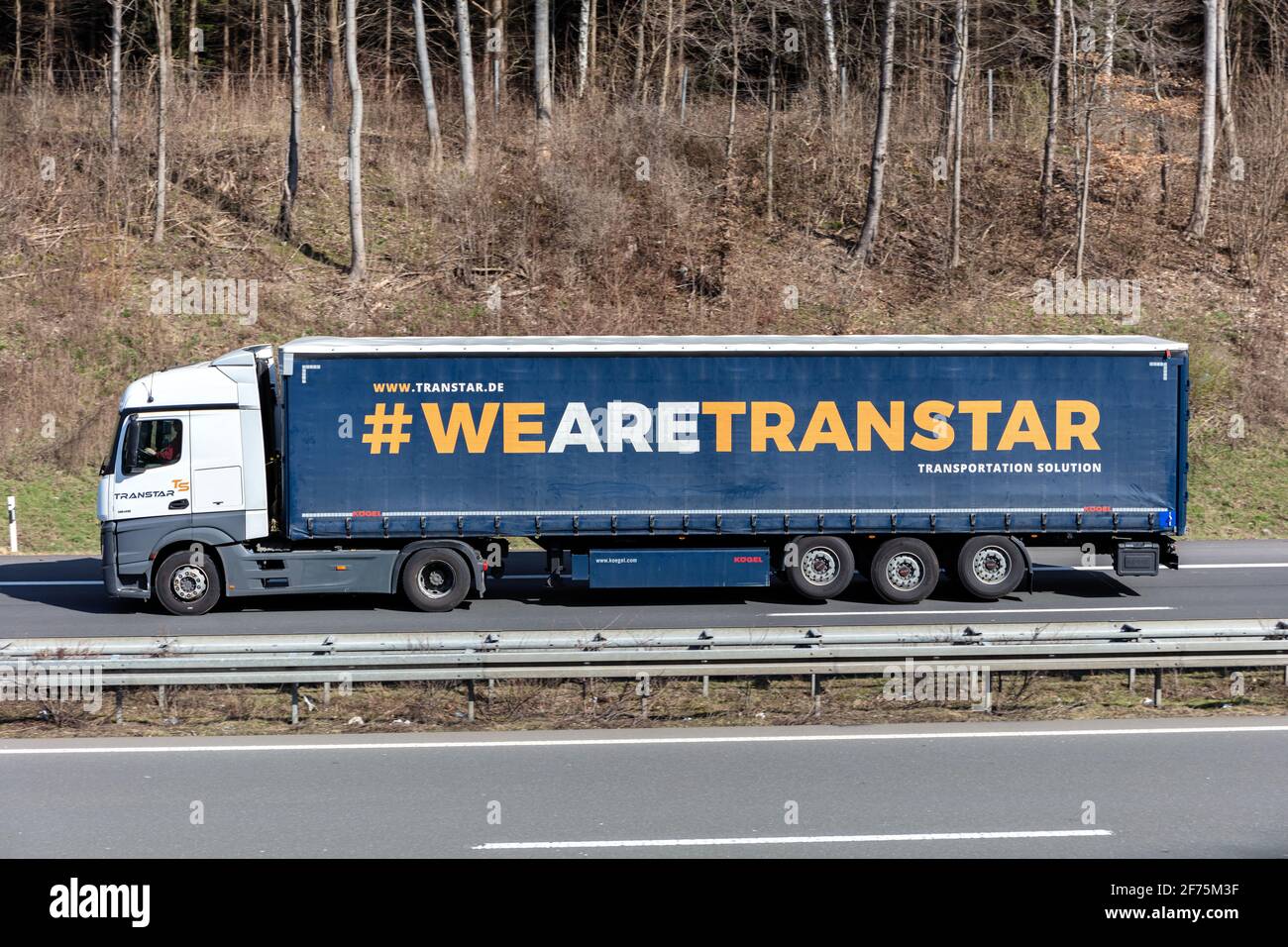 Transtar Mercedes-Benz Actros truck with curtainside trailer on motorway. Stock Photo