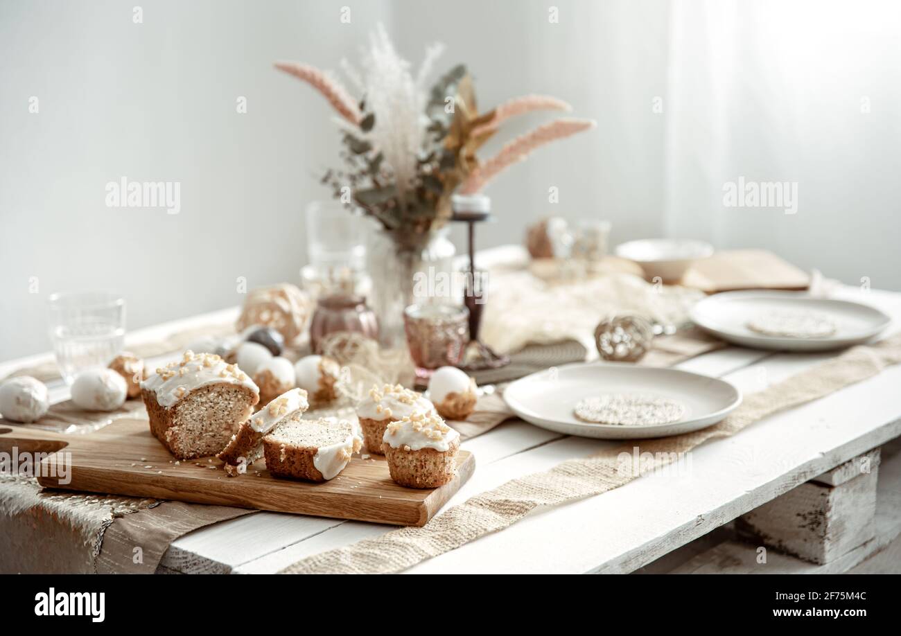 A festive table with a beautiful setting and freshly baked Easter pastries. Stock Photo
