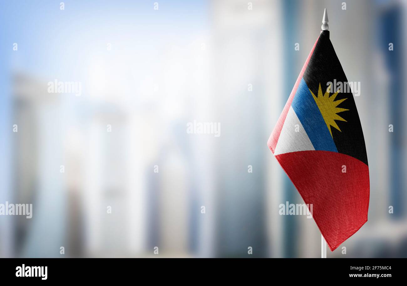 A small flag of Antigua and Barbuda on the background of a blurred background Stock Photo