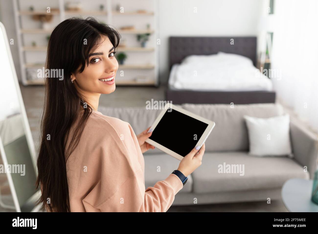 Woman using digital tablet with blank empty screen, mockup Stock Photo