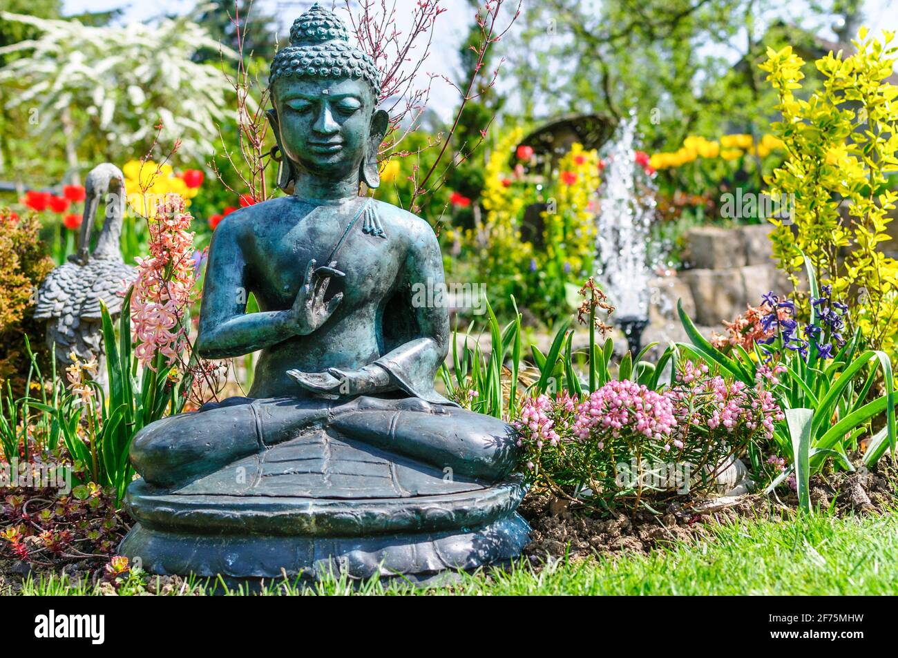 Buddha sculpture in ornamental garden Stock Photo Alamy