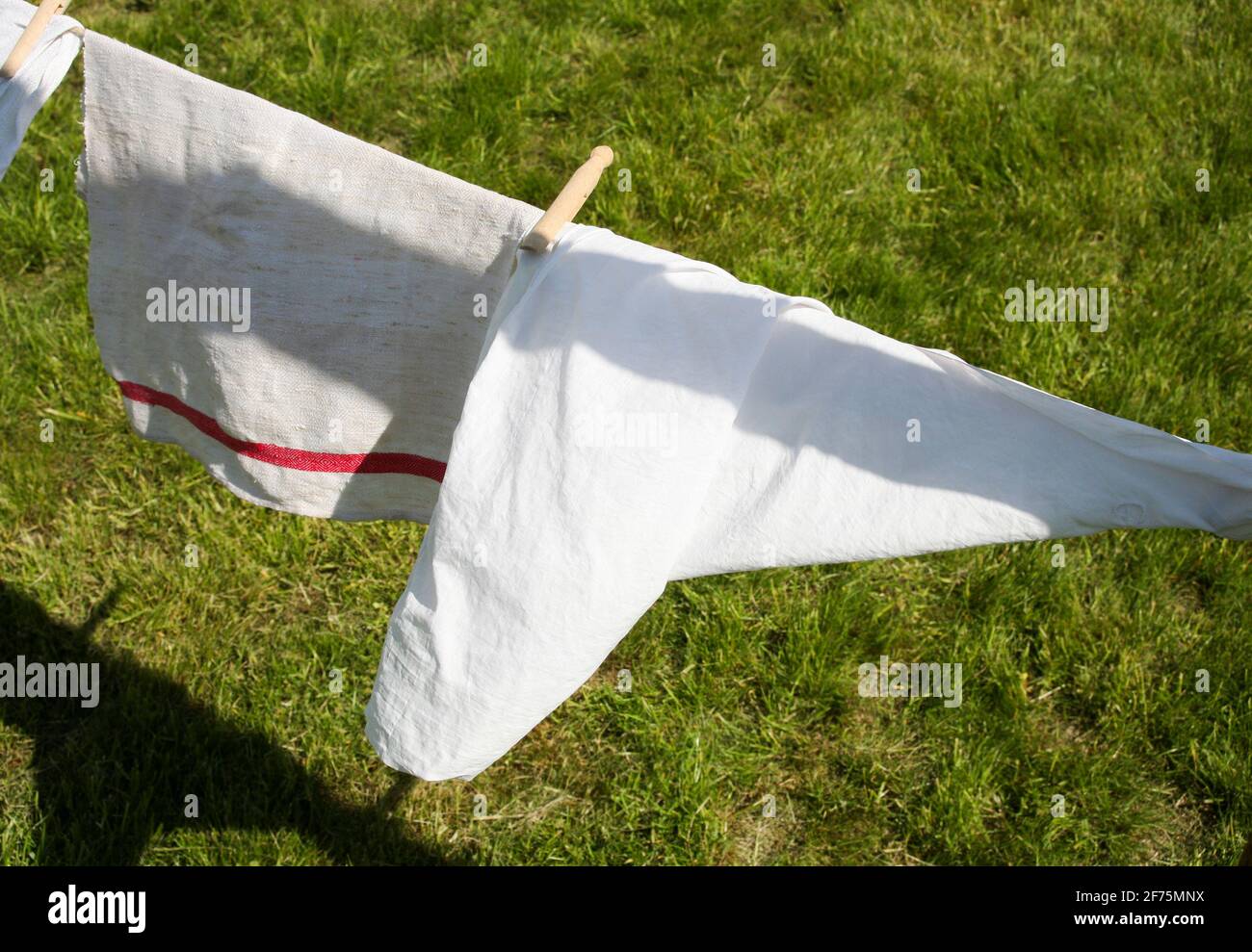 WASHED TOWELS hanging to dry in the sun Stock Photo