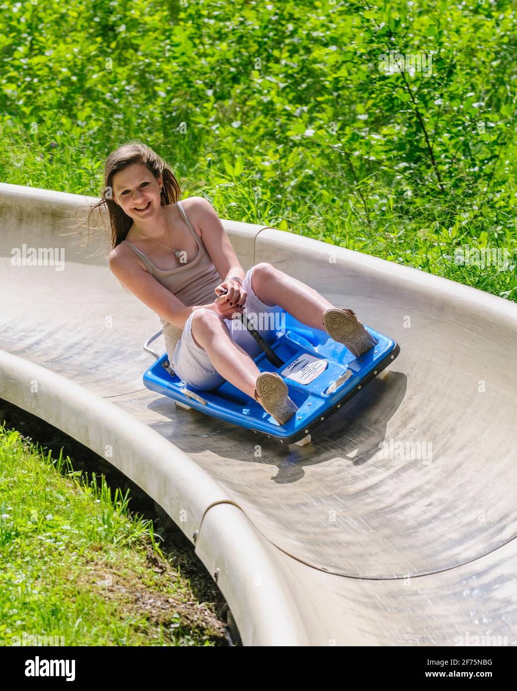 Family fun tobogganing in summer, up with the lift down with the