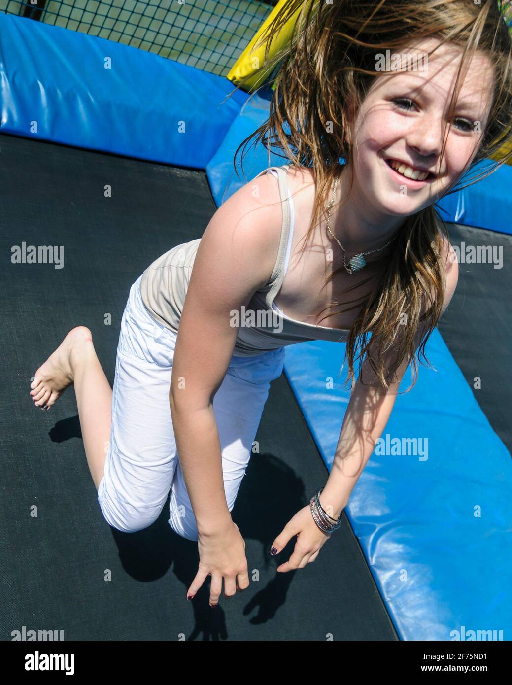 Fun on the trampoline - trains agility, coordination skills, balnace feeling and much more ... Stock Photo