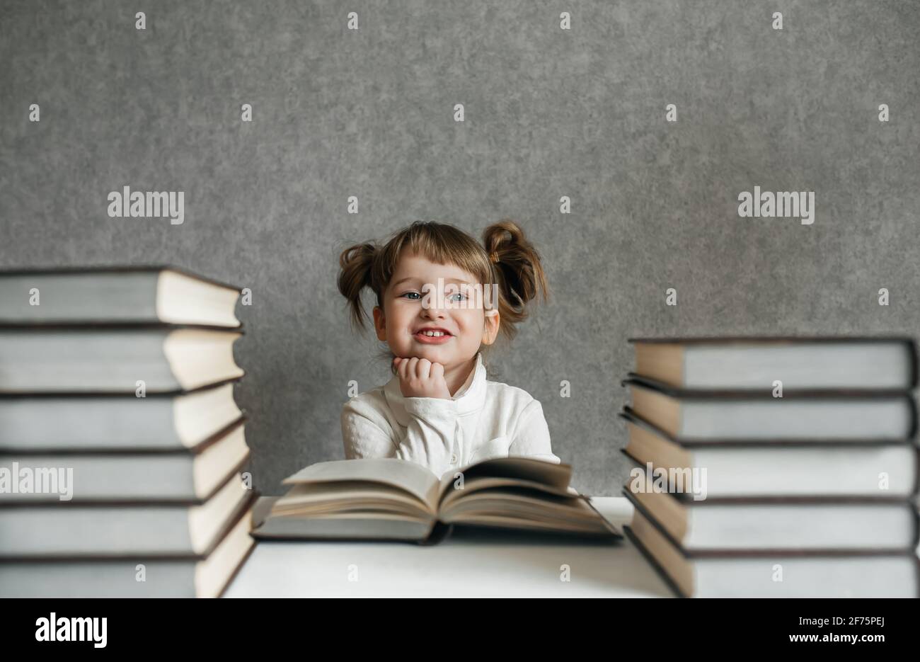 Happy funny baby girl in glasses reading a book Stock Photo - Alamy Happy funny baby girl in glasses reading a book Stock Photo - Alamy