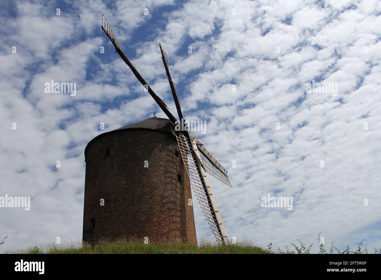 the historical tower mill of zeddam with a blue sky with little white clouds in the background in holland in summer Stock Photo