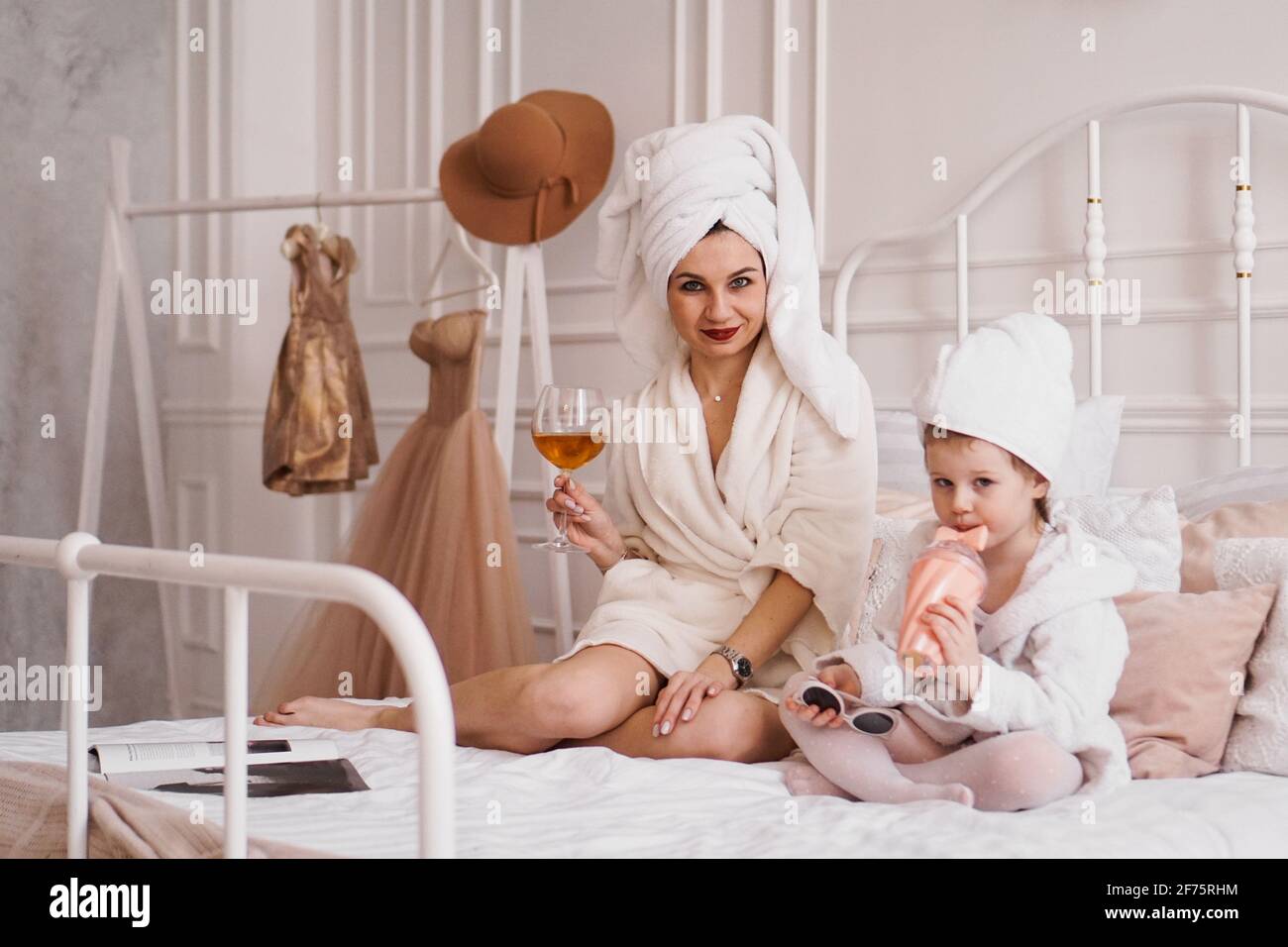 Mother and daughter in the bedroom in bathrobes Stock Photo - Alamy