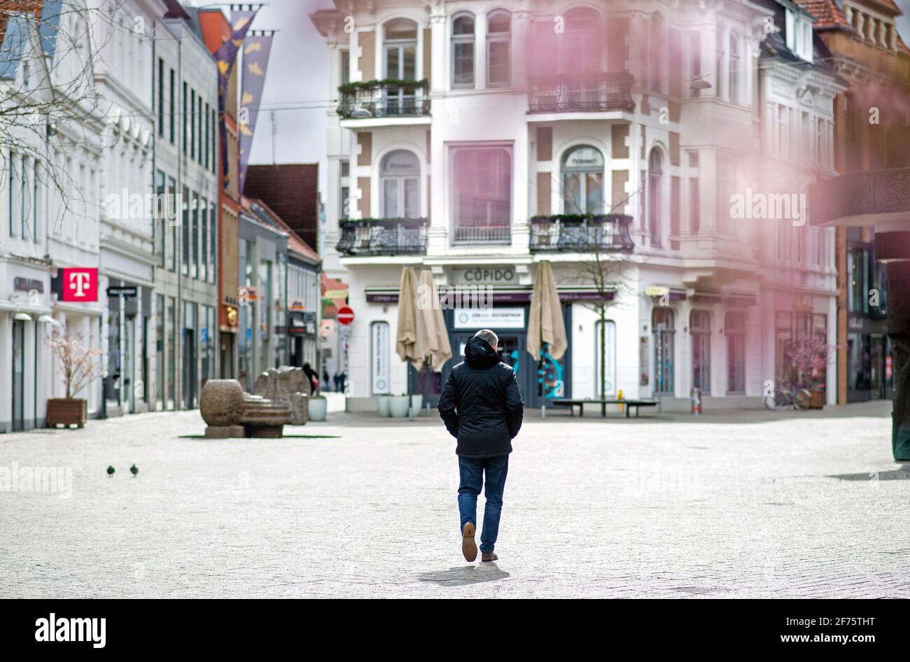 Oldenburg, Germany. 05th Apr, 2021. A man walks through the Lange Straße in the city centre. Despite high Corona infection figures, a cautious opening in Lower Saxony's inner cities is to get underway after Easter. The state government selected 14 municipalities for model projects to open shops, culture and outdoor gastronomy - including Oldenburg. Credit: Hauke-Christian Dittrich/dpa/Alamy Live News Stock Photo