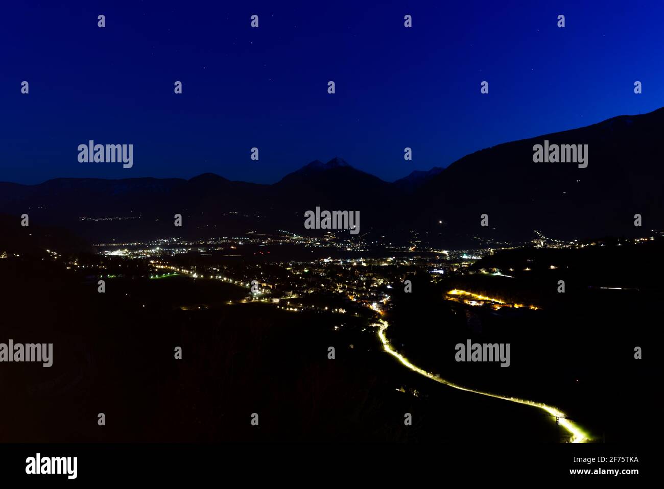 Schenna town in South Tyrol, Italy dramatic panoramic shot during a night in the spring of 2021. Stock Photo