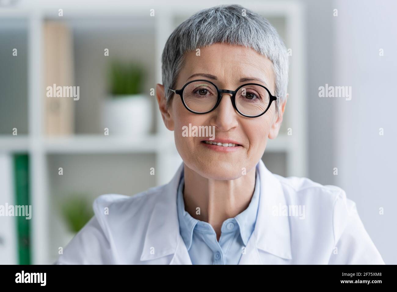Mature woman doctor smiling camera hi-res stock photography and images ...
