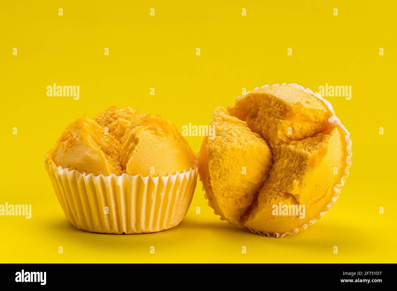 Side view closeup of homemade yellow cotton candy with golden egg yolk threads on yellow background Stock Photo