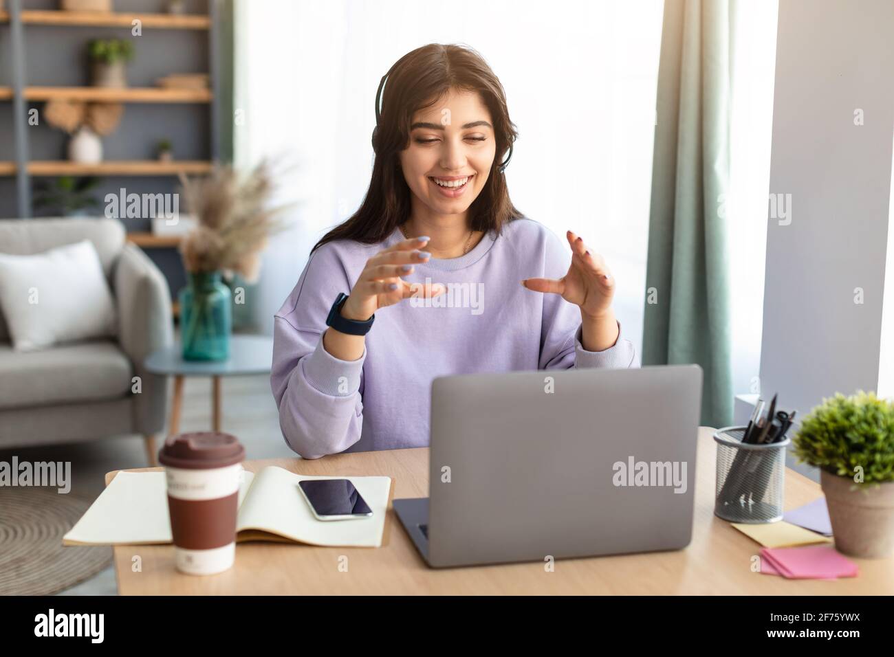 Female teacher having video call using laptop and talking Stock Photo ...