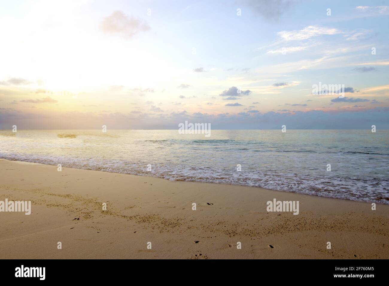 Sandy beach with the blue ocean and sunset sky background Stock Photo ...
