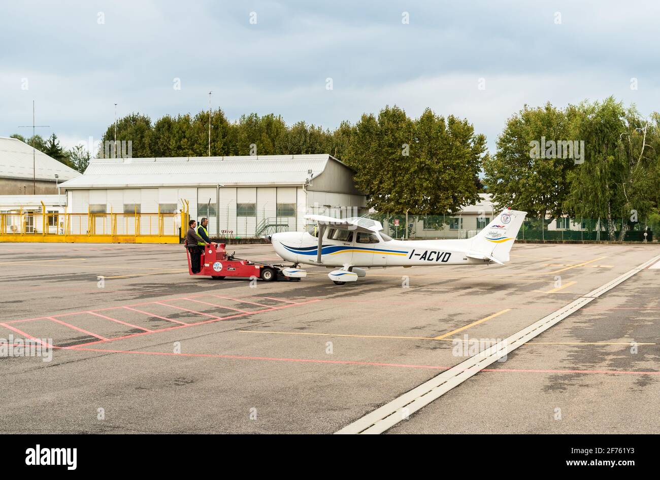 Venegono Inferiore, Varese, Italy - September 02, 2017: Workers moving Cessna 172 SP Aircraft to hangar, is the fleet of Aero Club of Varese. Stock Photo