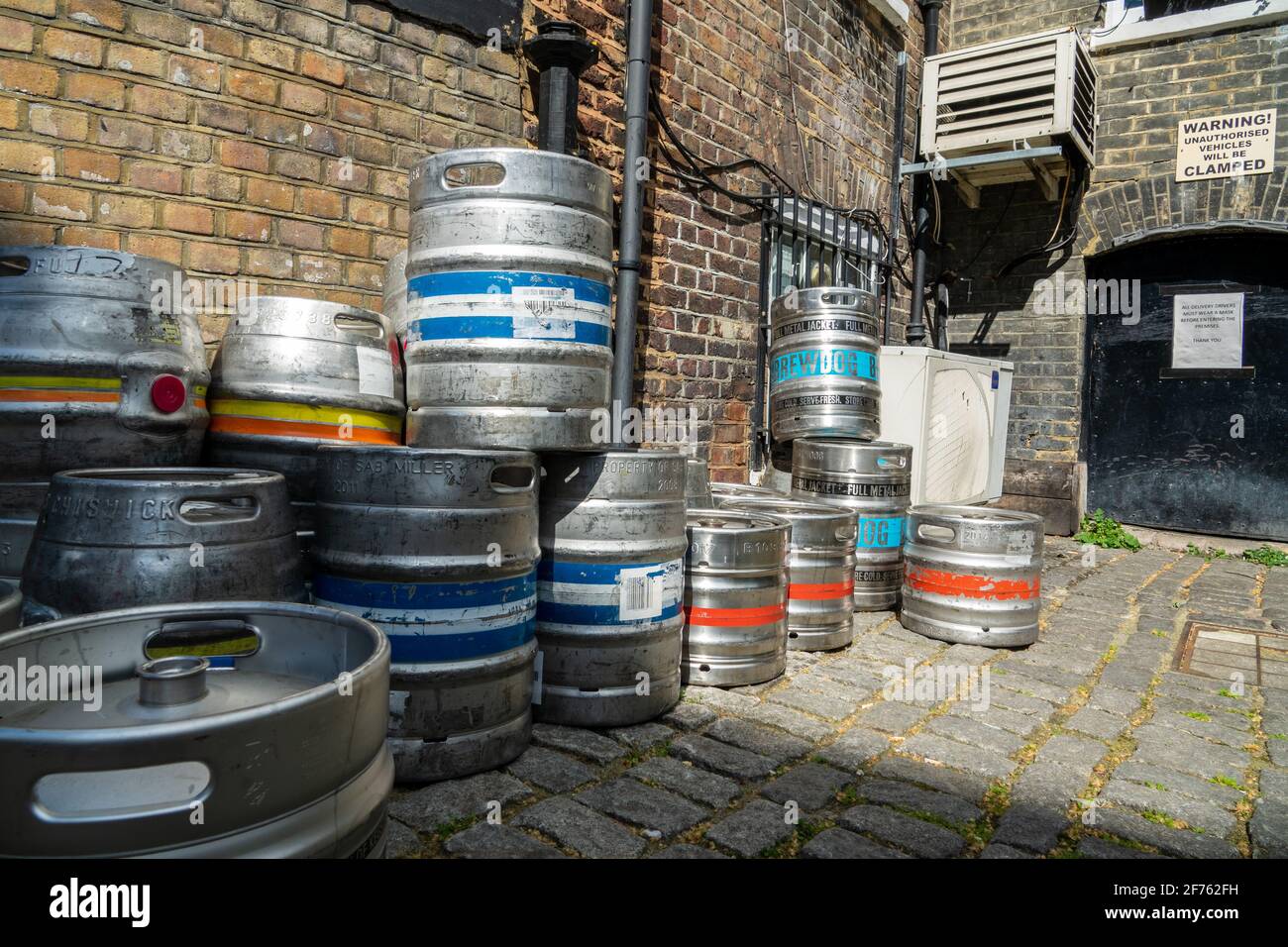 Beer kegs stacked outside a pub beer cellar in preparation for pubs