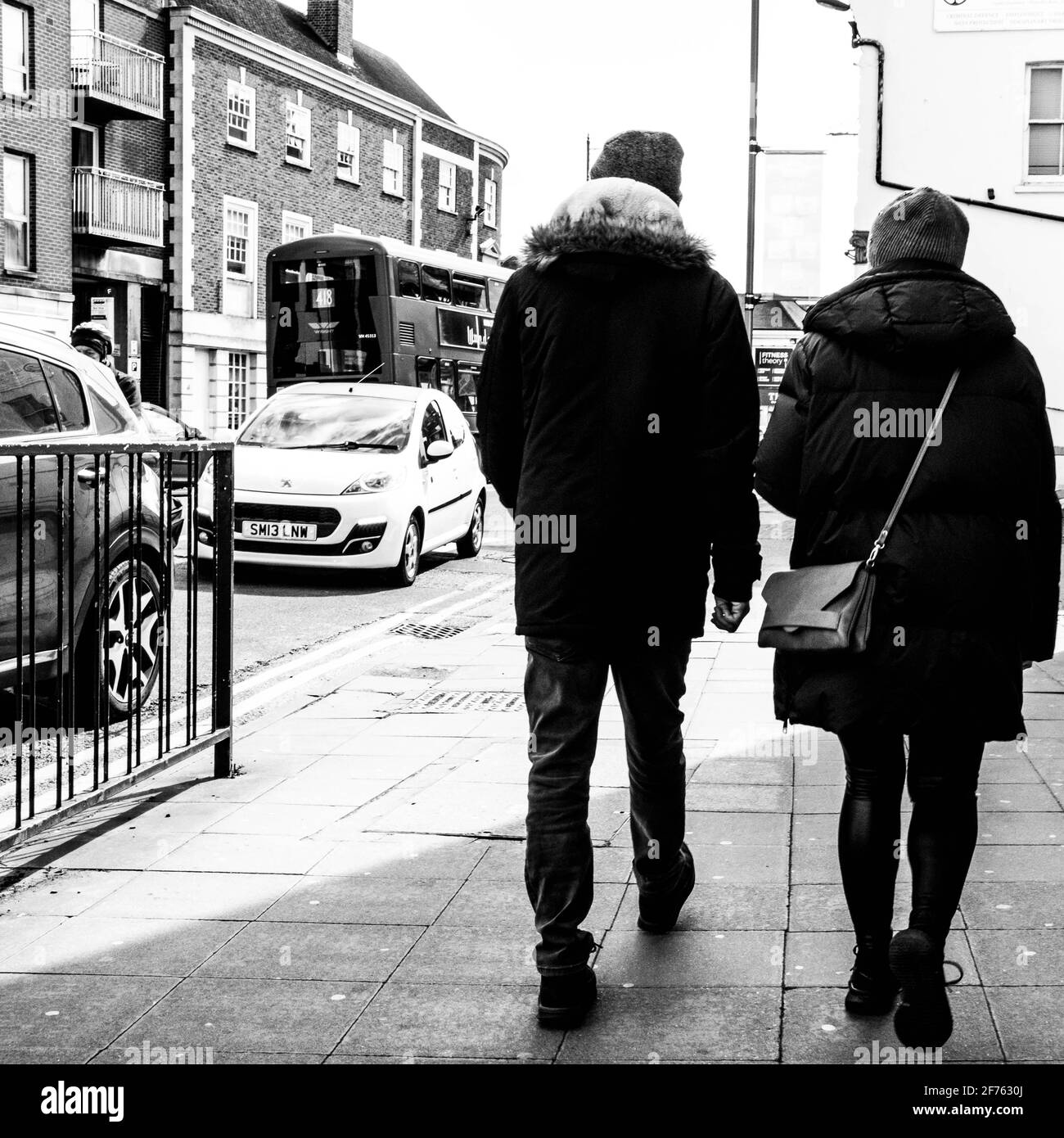 Epsom Surrey, London UK, April 5 2021, Man and Woman Couple Walking Along A Pavement On A London High Street Stock Photo