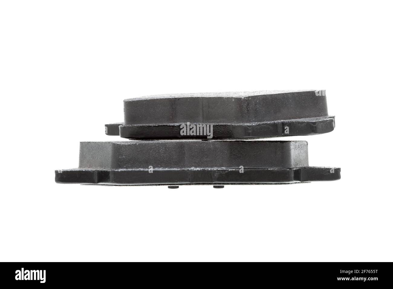 brake pads one on top of the other demonstrate the thickness of asbestos abrasive alloy, new car spare parts isolated on white background side view. Stock Photo