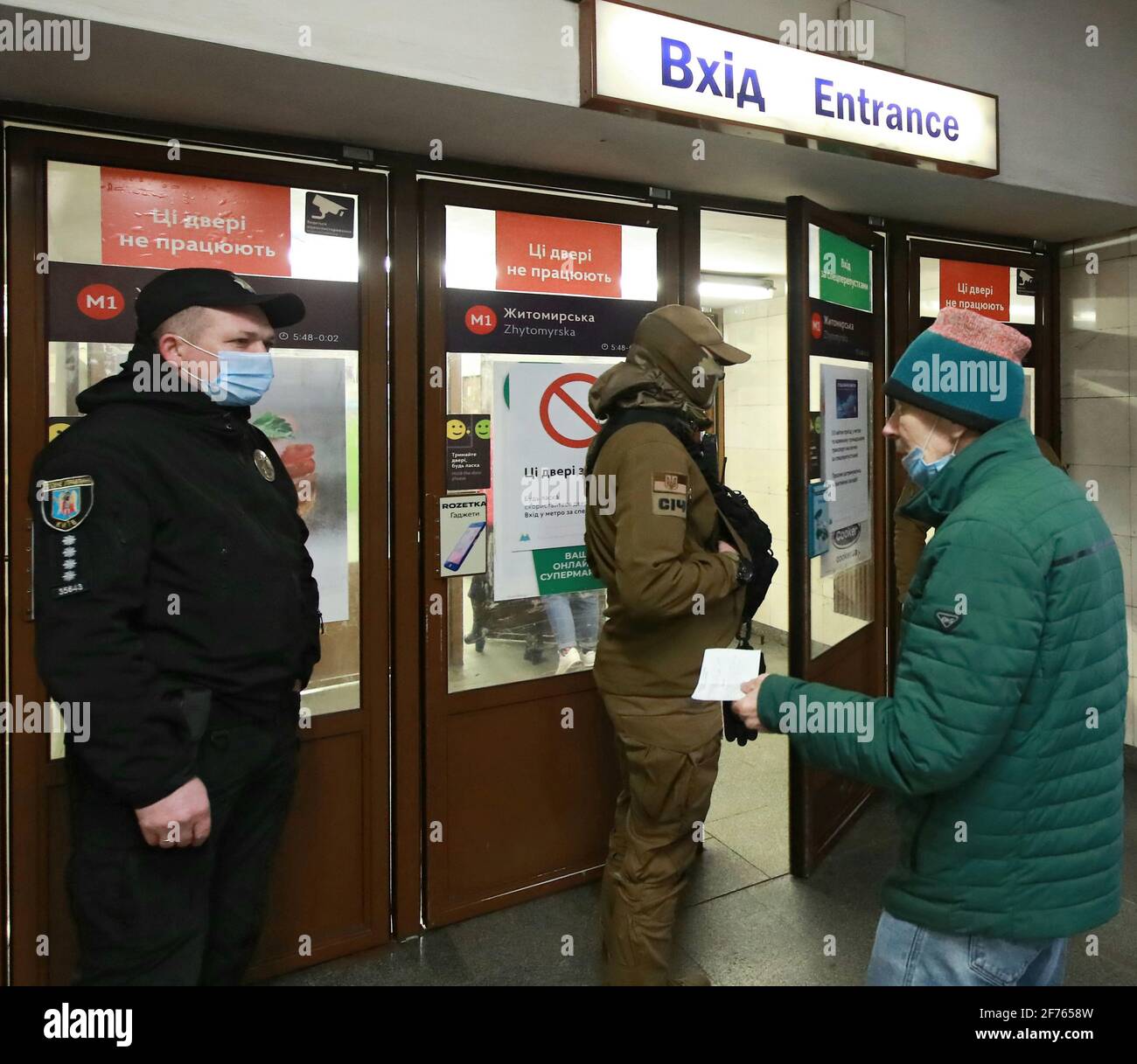 KYIV, UKRAINE - APRIL 05, 2021 - A man shows his documents to a police officer at the entrance to the Zhytomyrska metro station, Kyiv, capital of Ukraine Credit: Ukrinform/Alamy Live News Stock Photo