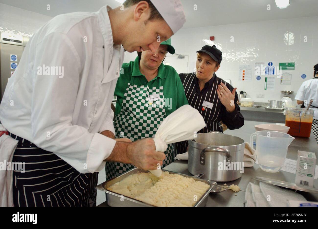 SIMON OWEN , CAROLINE LEE AND LIZ KAVANAGH ,IN THE TRAINING KITCHEN   FOR SCHOOL COOKS IN ESSEX. 2/12/05 TOM PILSTON Stock Photo