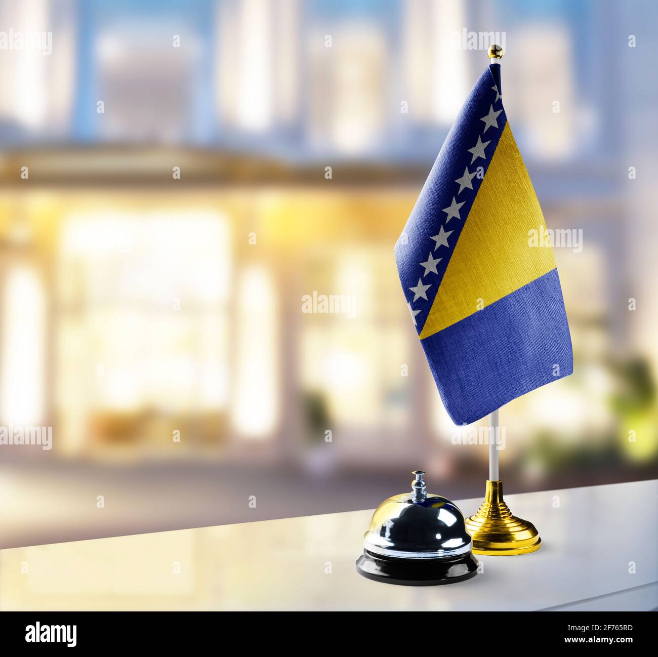 Bosnia and Herzegovina flag on the reception desk in the lobby of the hotel Stock Photo