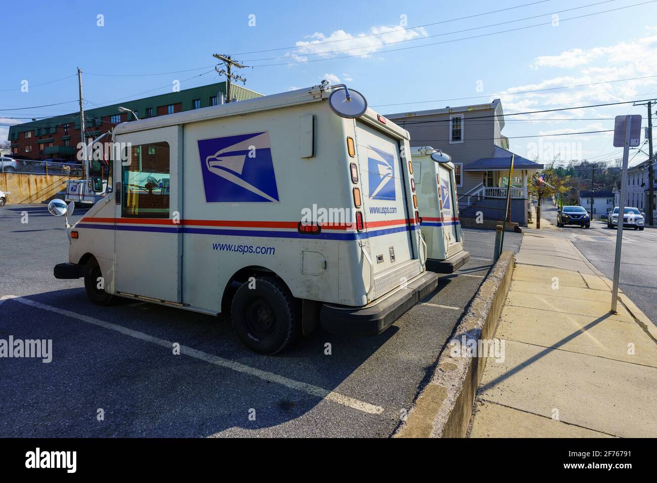 Ephrata, PA, USA - April 4, 2021: USPA Mail delivery trucks parked at the Ephrata Post Office in Lancaster County, PA. Stock Photo