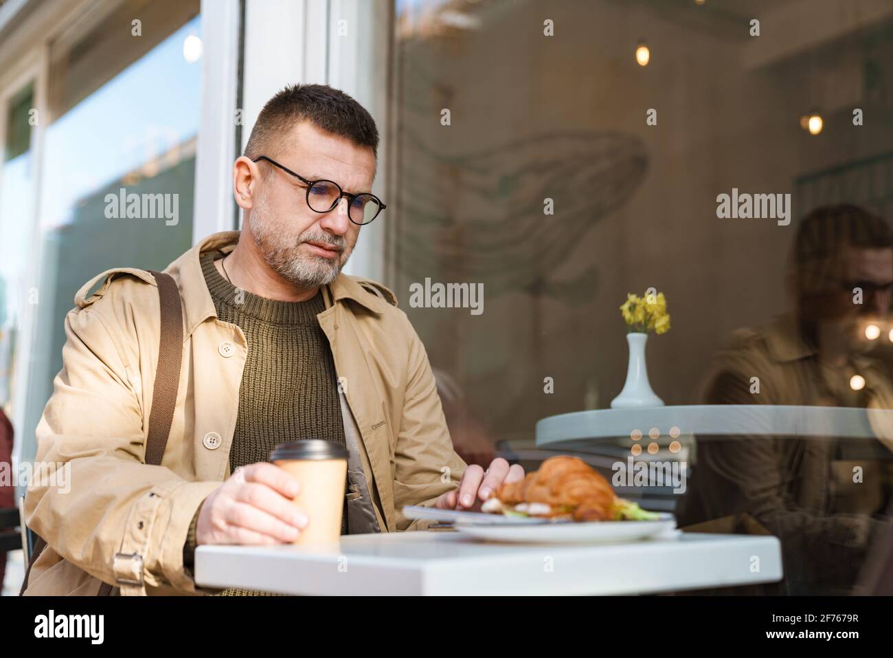 Young Man Texting Message On Smart Phone While Enjoying Free Wireless Young man texting message on smart phone while enjoying free wireless