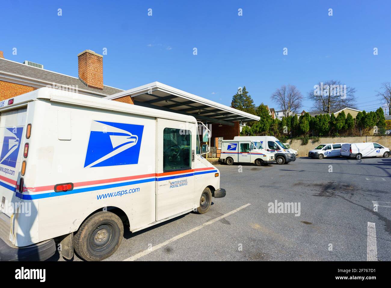 Ephrata, PA, USA - April 4, 2021: USPA Mail delivery trucks parked at the Ephrata Post Office in Lancaster County, PA. Stock Photo