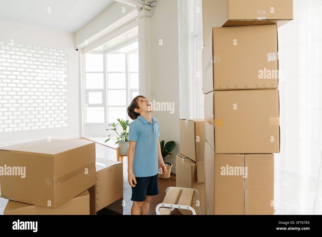 Excited and shocked caucasian cute little boy staring and pile of