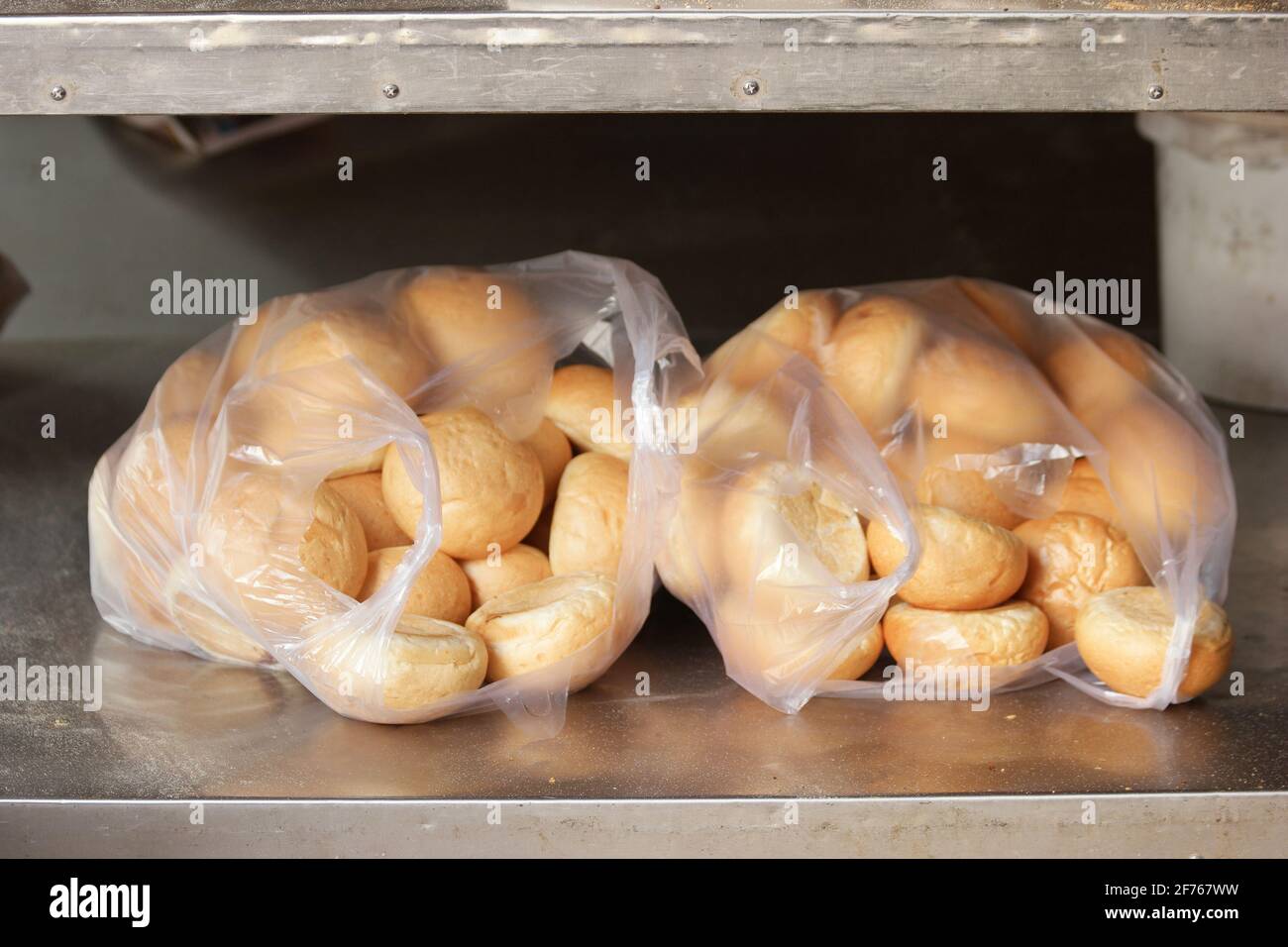 Round bread buns in plastic bags Stock Photo Alamy