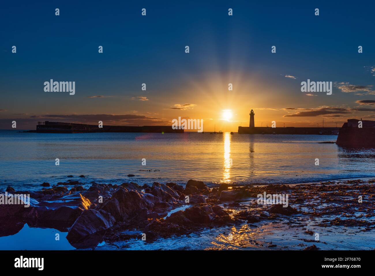 Just a few minutes after sunrise on midsummer morning at Donaghadee harbour, County Down, Northern Ireland. Stock Photo
