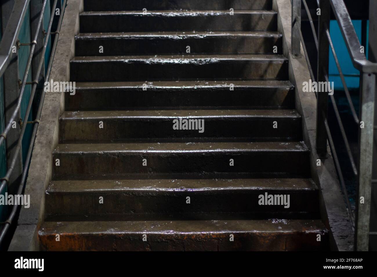 Staircase in a pedestrian crossing. Dirty stairs in artificial light. Steps up. A flight of stairs in a street building. Stock Photo