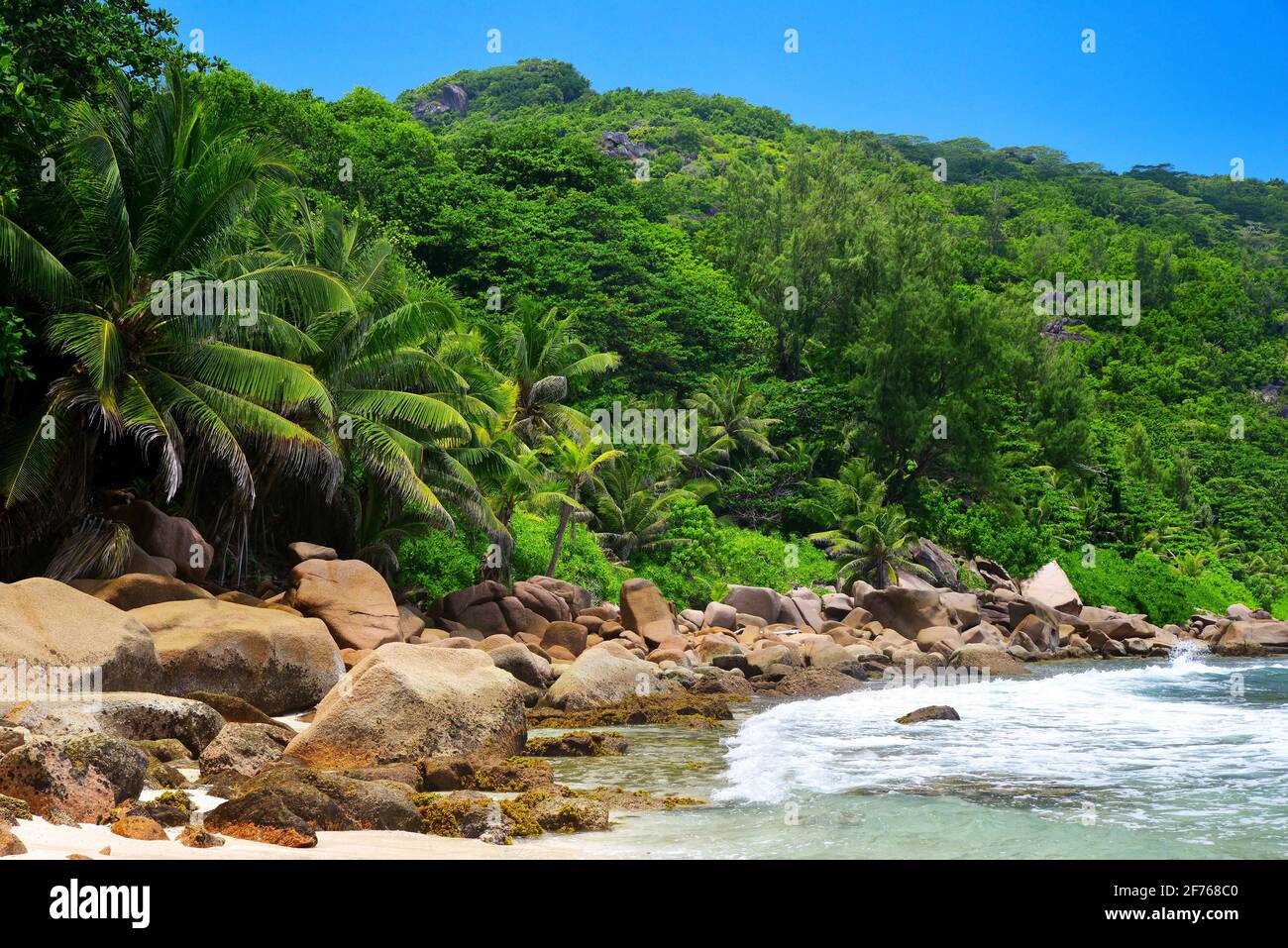 Coast with big granite stones at Anse Caiman beach in La Digue Island, Seychelles. Stock Photo