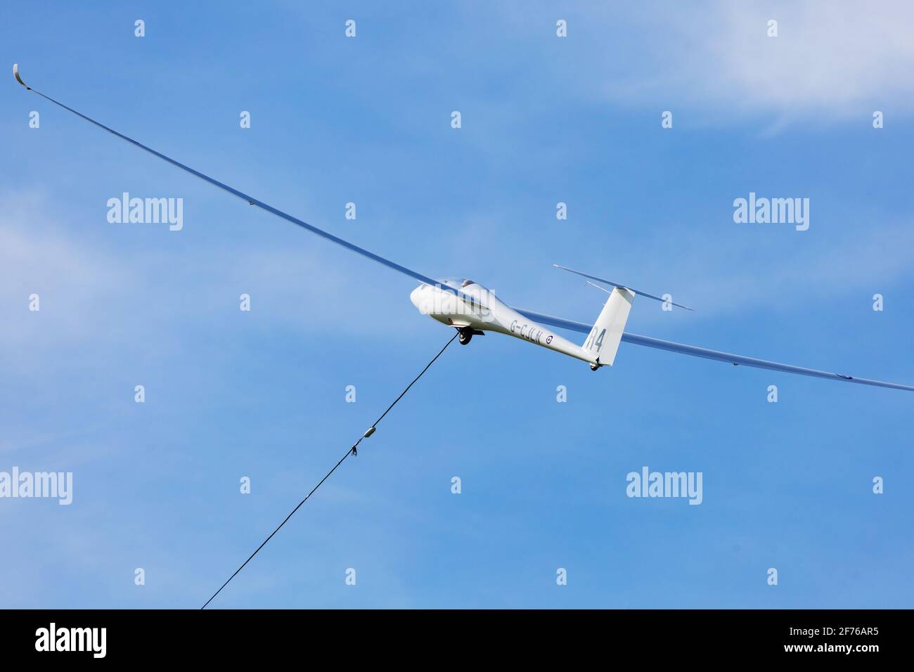 RolladenSchneider LS8, 18m glider of the RAFGSA, winch launching into blue sky. Cranwell
