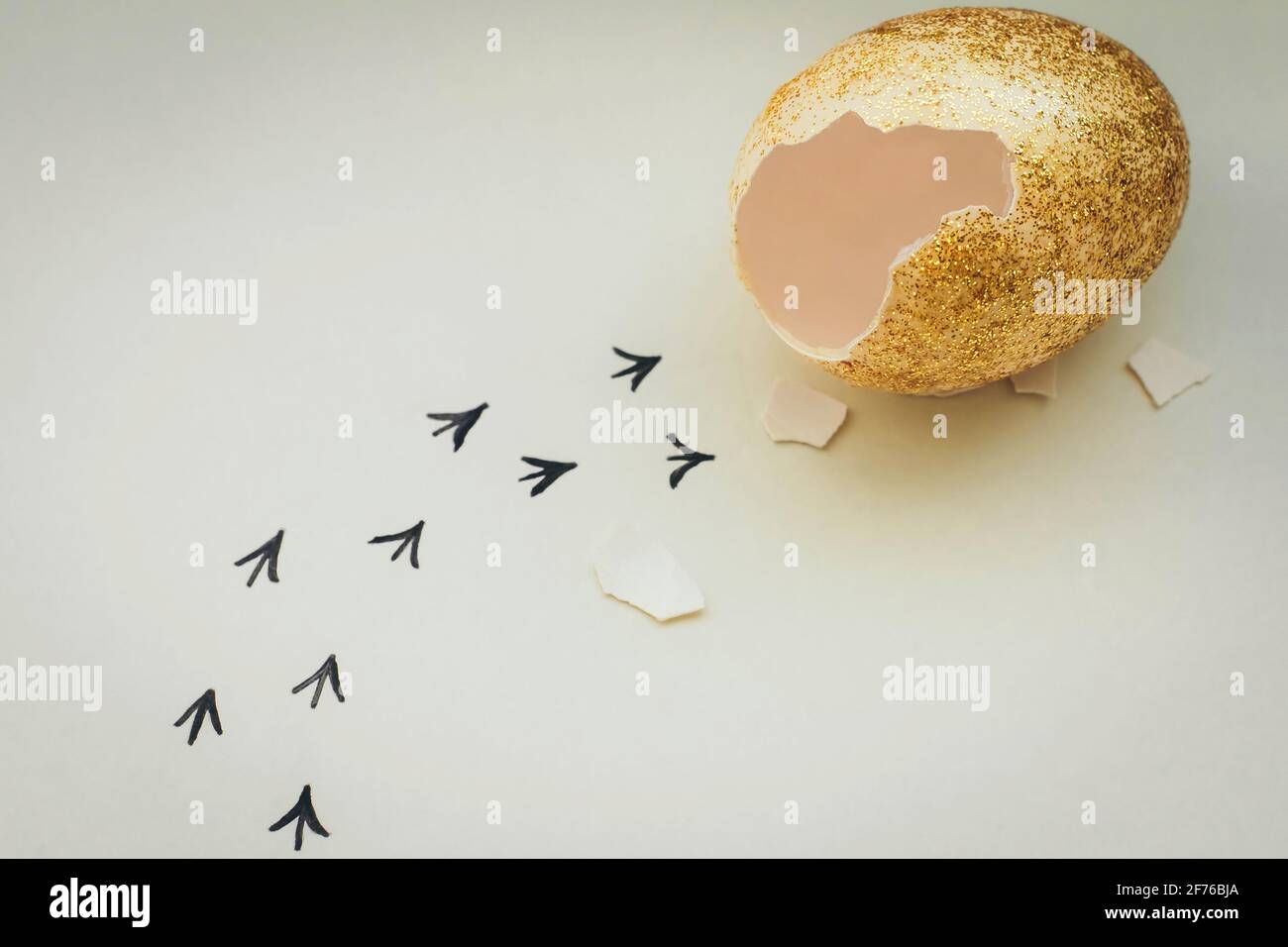 Footprints from an egg shell. First steps of a chick on a white isolated background. Concept of way out of the comfort zone, a new life, progress Stock Photo