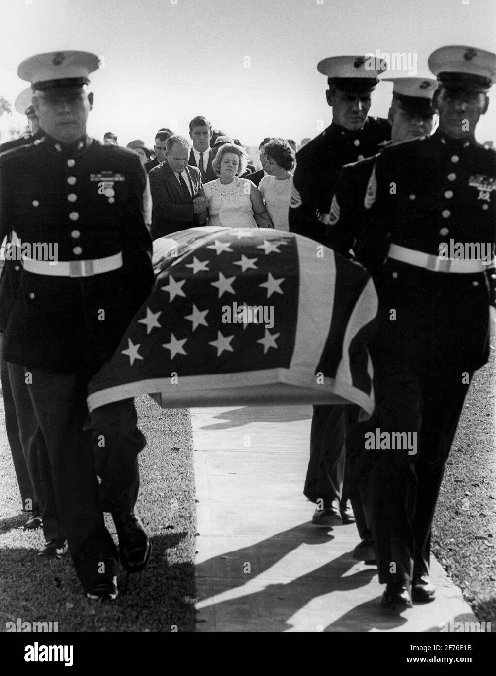 Pregnant wife and family of a Vietnam soldier killed in action, follows his casket during a military burial ceremony in South Florida, CA 1960's. Stock Photo
