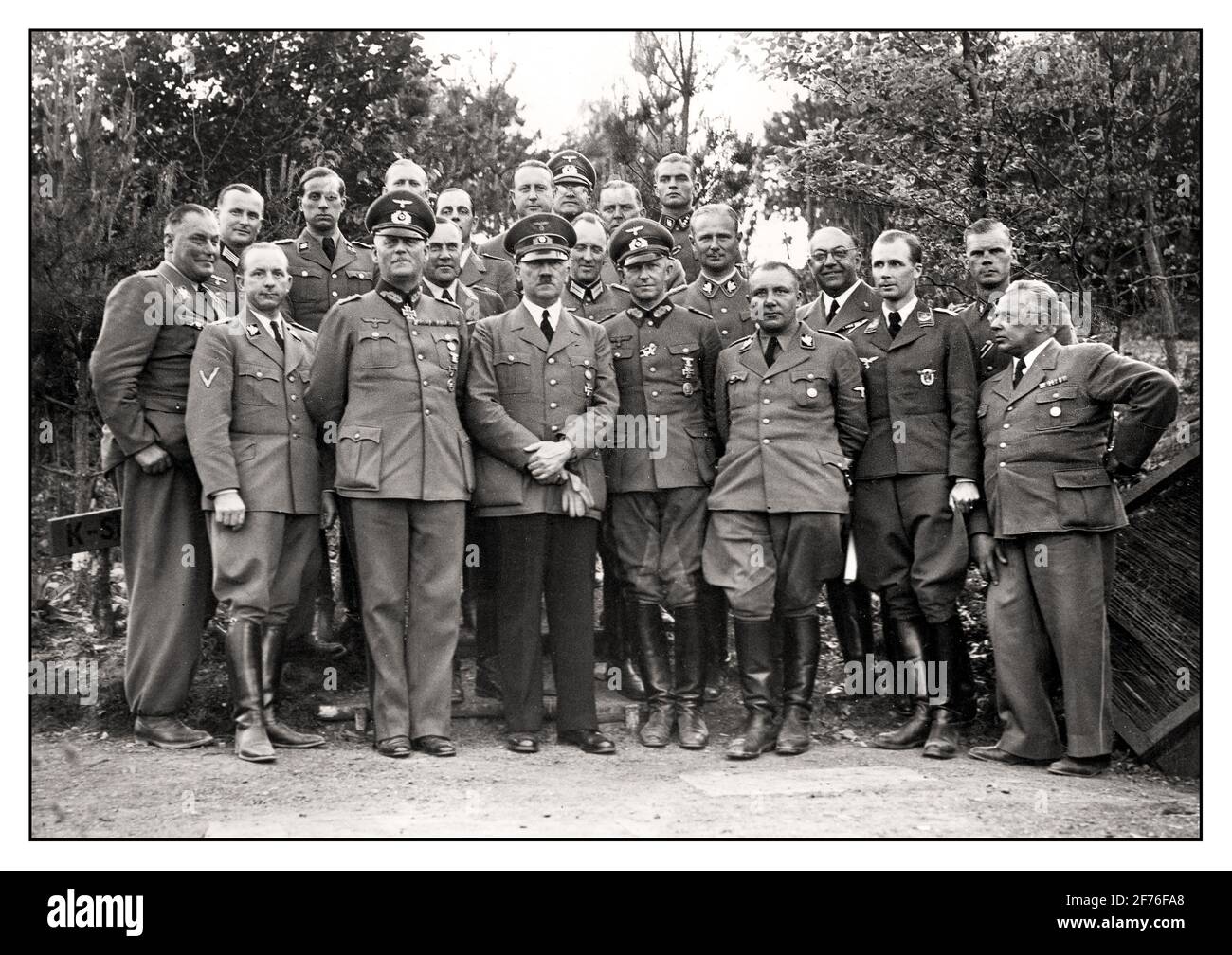 Fascist Nazi Fuhrer leader Hitler with his staff at the headquarters In June 1940, Hitler and his entourage had themselves photographed at the Führer headquarters, it can be assumed that this photo was taken in the 'Wolfsschanze' (built from 1940–1942). As far as known from left to right: SA-Obergruppenführer Wilhelm Brückner, OKH-Adjutant Major Engel, Reich Press Chief Dr. Otto Dietrich, Hitler's attending physician Dr. Karl Brandt, Chief of the OKW Colonel General Wilhelm Keitel, Air Force Adjutant Major General [Karl] Bodenschatz, Adolf Hitler, Wehrmacht adjutant Colonel Rudolf Schmundt, SS Stock Photo