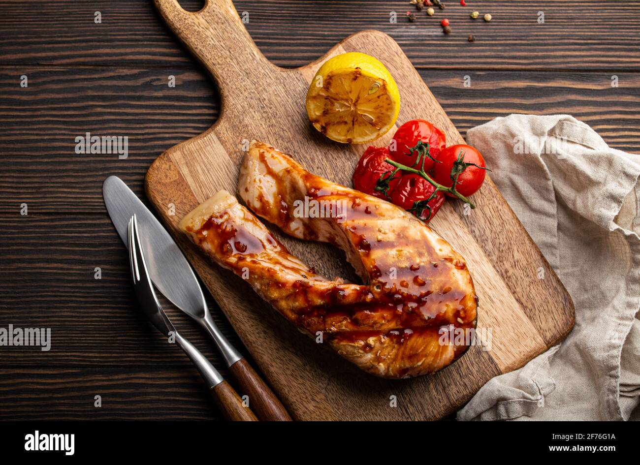 Grilled salmon steak on dark wooden background Stock Photo - Alamy