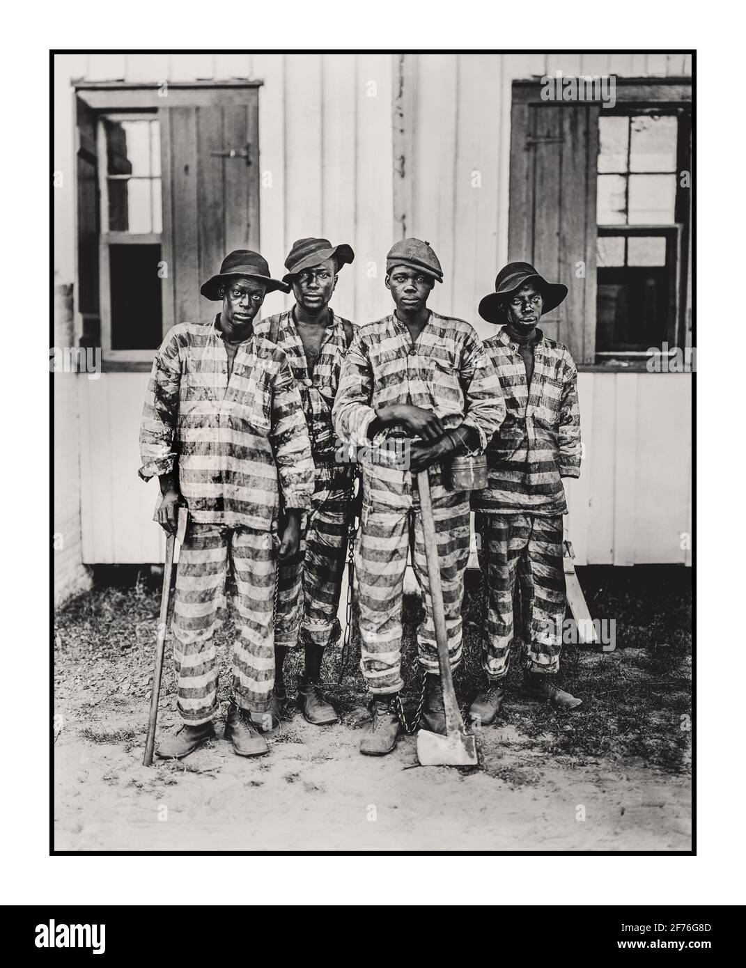 A southern chain gang of African American prisoners outside with their work tools. They were forced to perform hard menial tasks as an added form of punishment. Usually found in southern states of America USA 1900-1906 Stock Photo